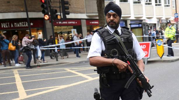 An armed police officer attends the scene of a knife attack in Russell Square in London
